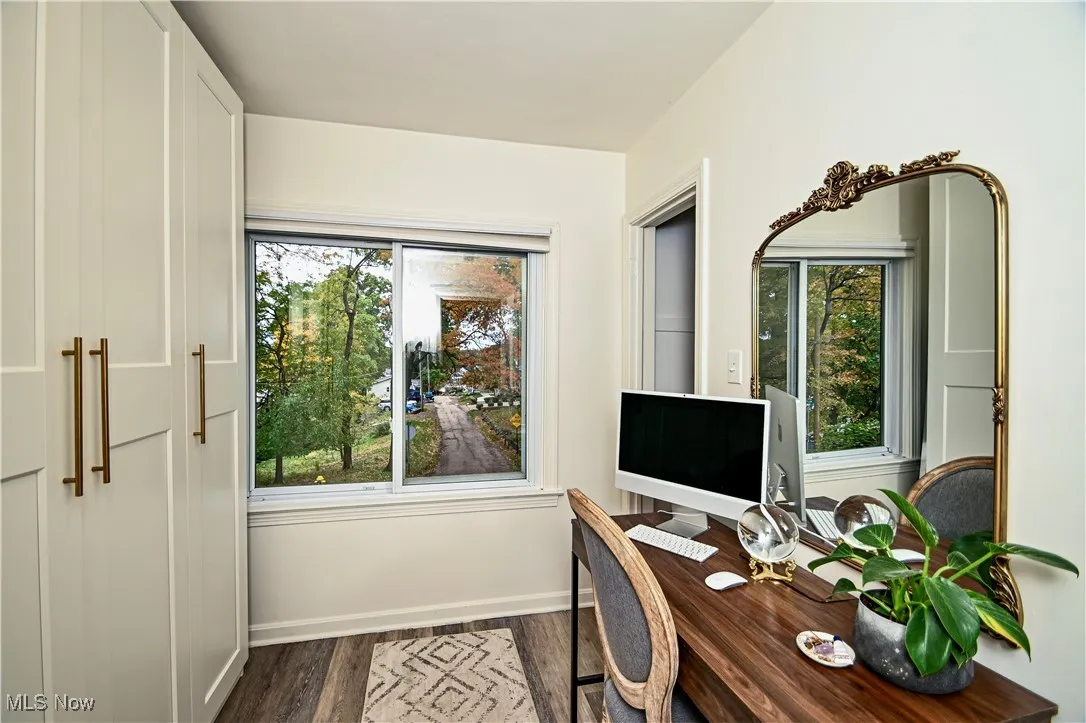 Office area with plenty of natural light and dark wood-style floors
