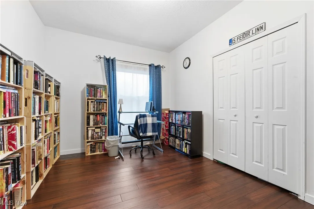 Living area featuring dark wood finished floors and an office area