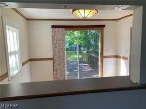 Looking from the living room featuring crown molding