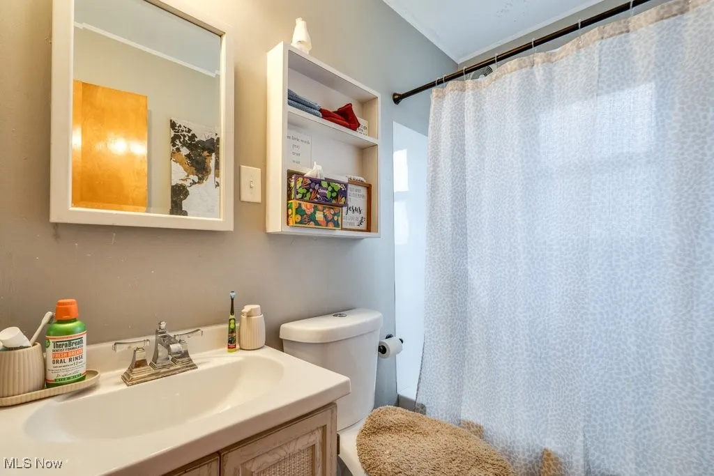 Full bath featuring vanity and shower / bath combo with shower curtain