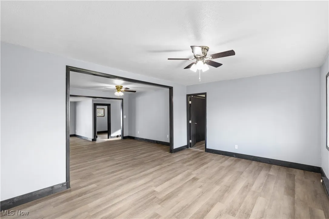 Spare room with light wood finished floors and ceiling fan