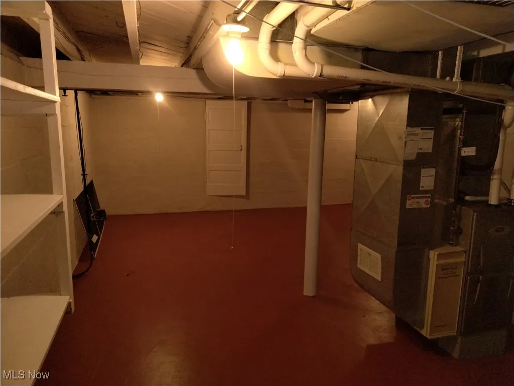 Unfinished basement featuring heating unit