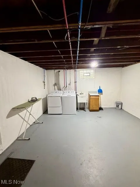 Below grade area with washing machine and clothes dryer