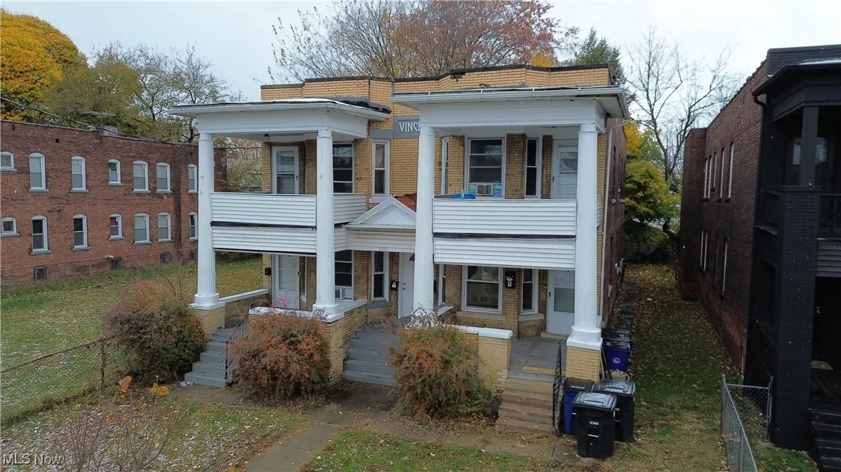 Neoclassical / greek revival house featuring covered porch