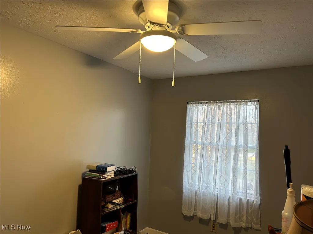 Bedroom featuring a textured ceiling and ceiling fan