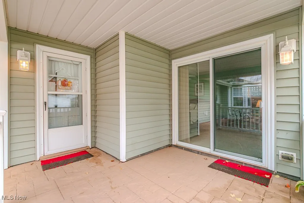 Rear entry of the home that enters into the laundry room & the primary suite slider to the primary bedroom with fireplace!