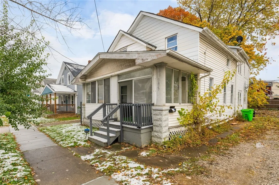 View of front of home featuring a sunroom