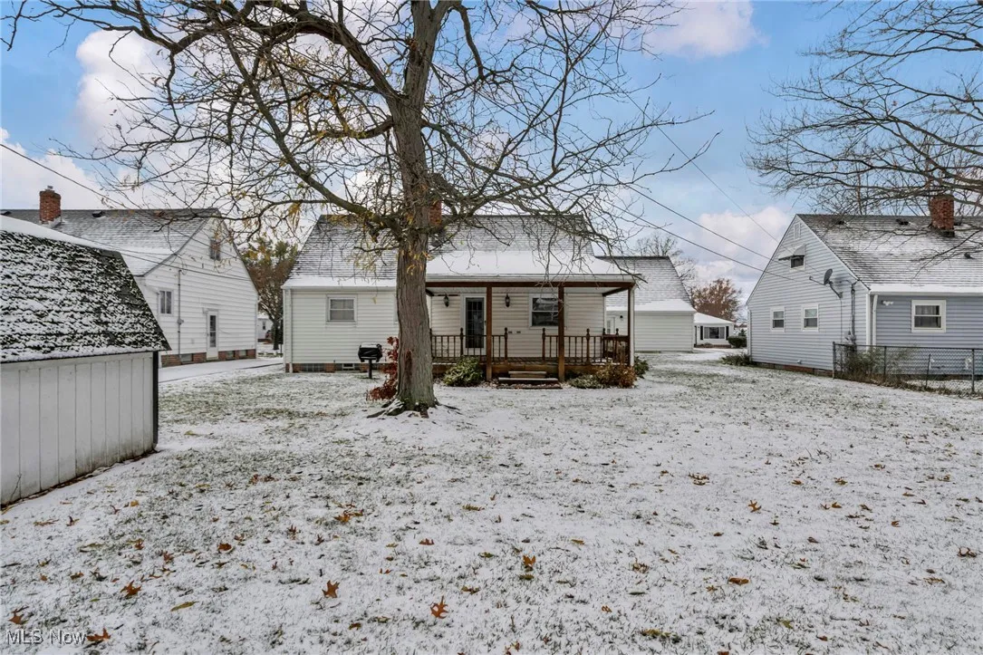 Snow covered property with a deck