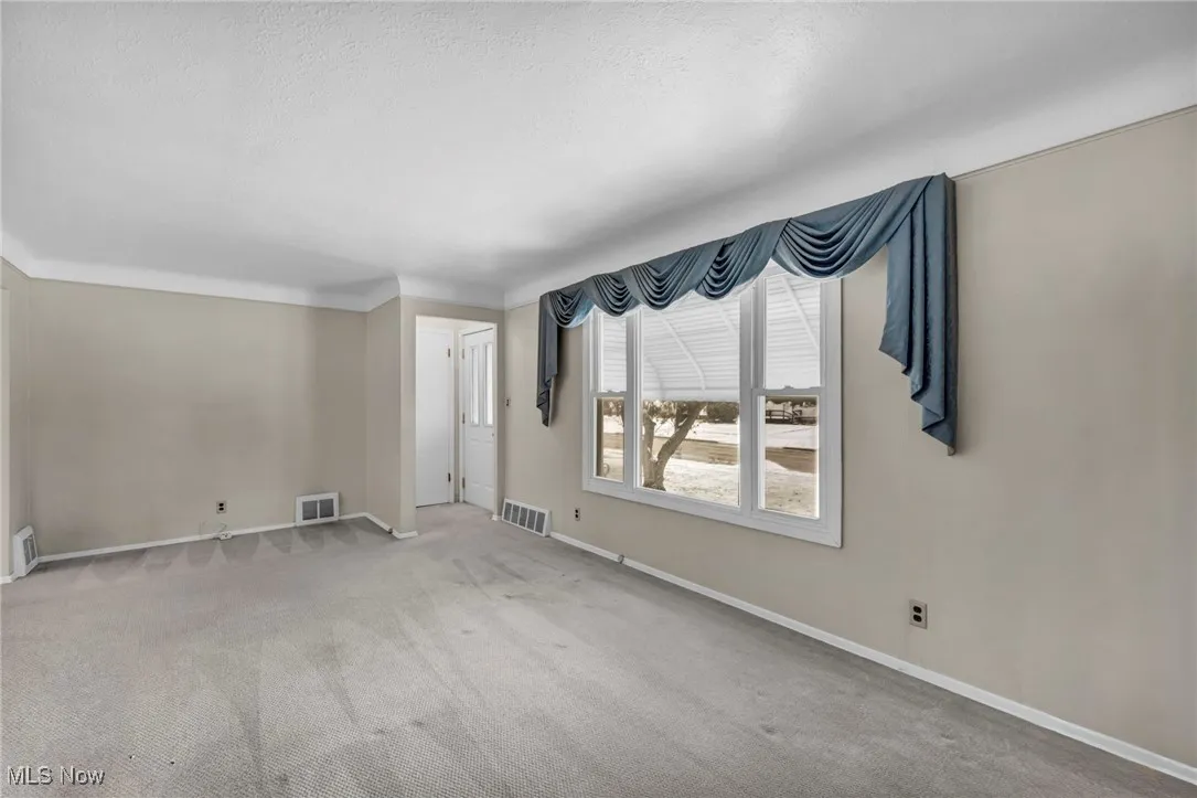 Spare room with carpet and a textured ceiling