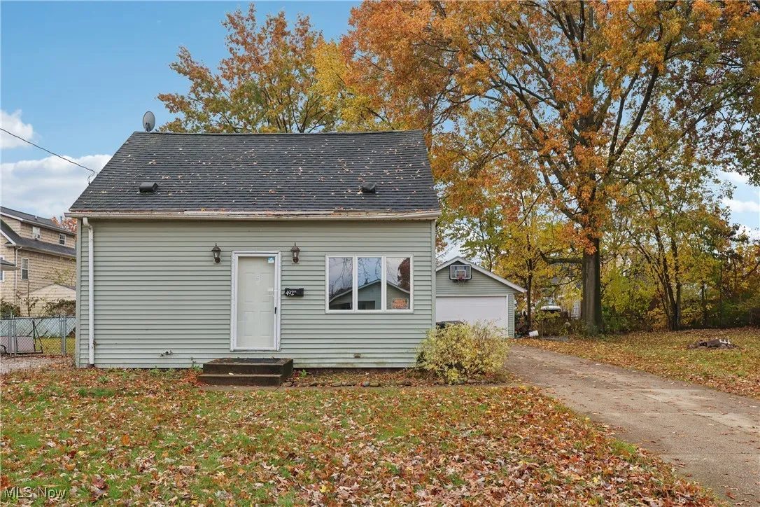 Front of property with a driveway and 2 car detached garage