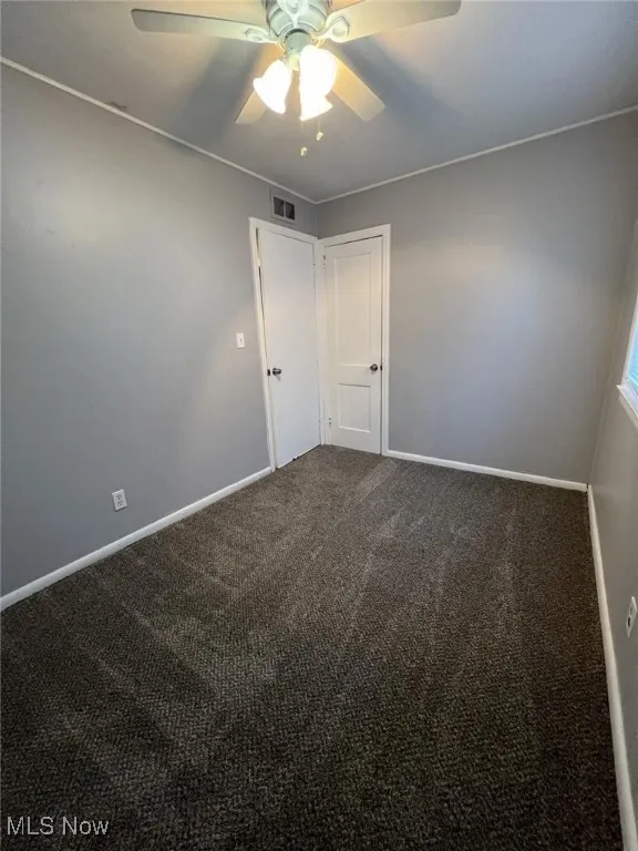 Spare room with carpet flooring and ceiling fan
