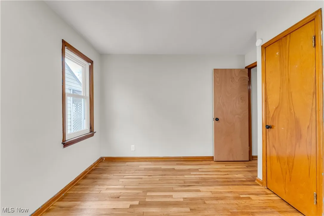Unfurnished bedroom with light wood-type flooring and a closet