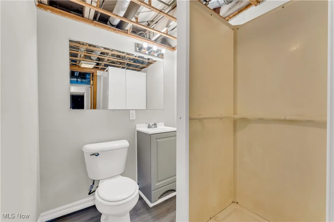 Half bath featuring vanity and wood finished floors