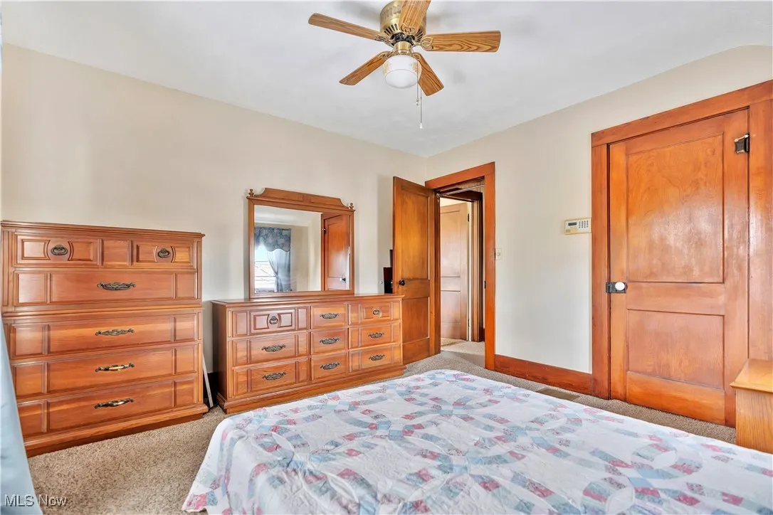 Bedroom #2 with light carpet and ceiling fan