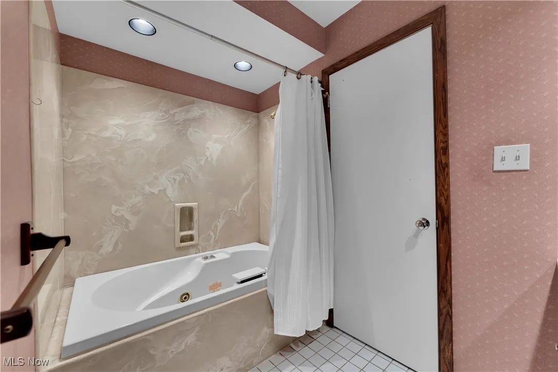 Full bathroom featuring a combined bath / shower with jetted tub, wallpapered walls, tile patterned floors, and recessed lighting