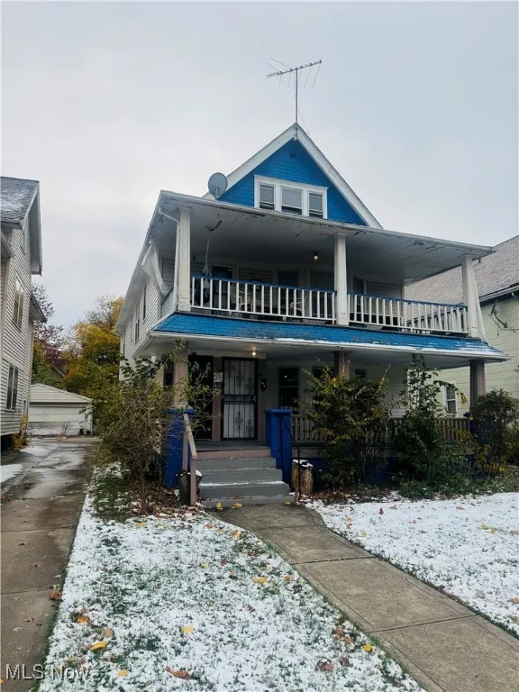 View of front facade with a balcony and a porch