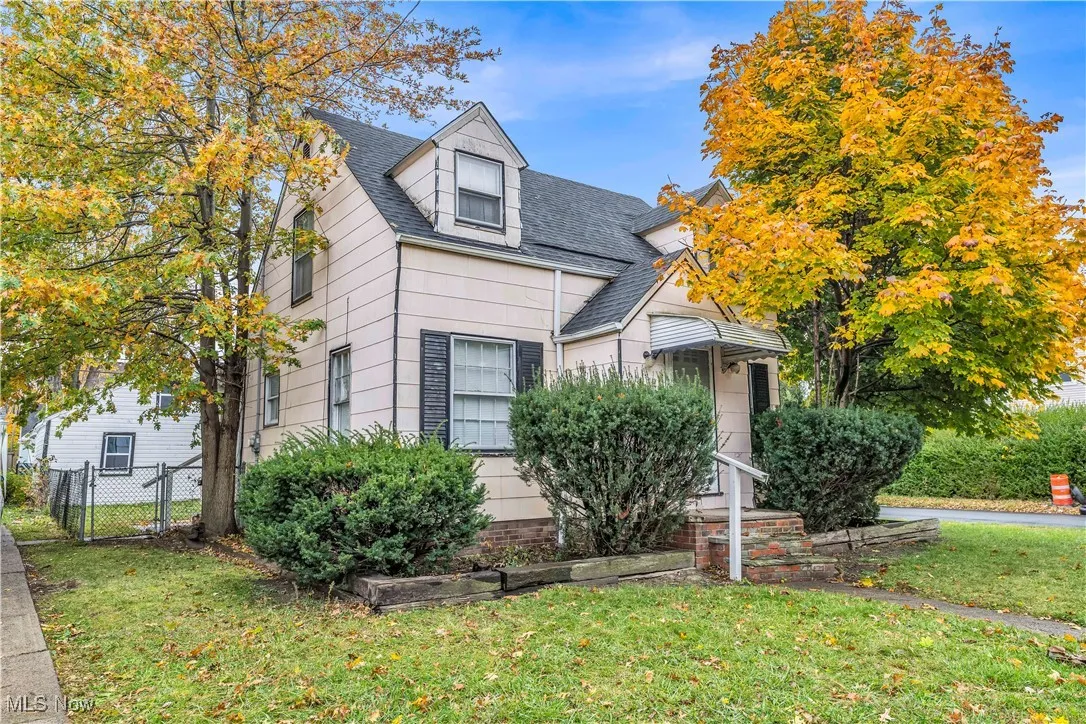 View of front of property with roof with shingles and a gate