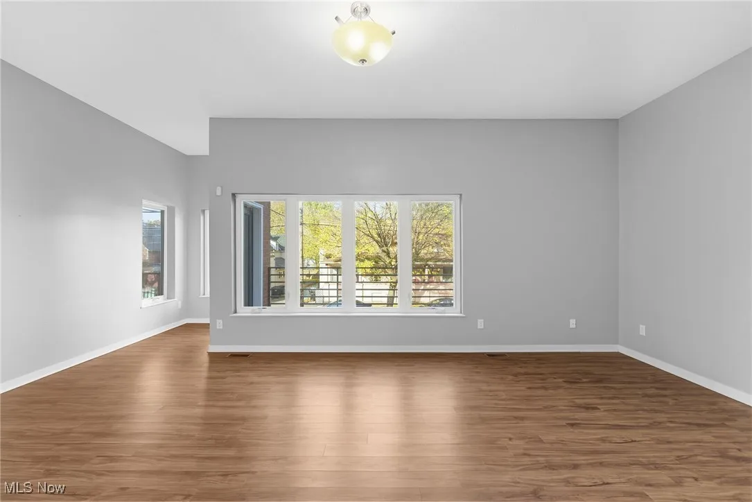 Unfurnished room featuring dark wood-style flooring