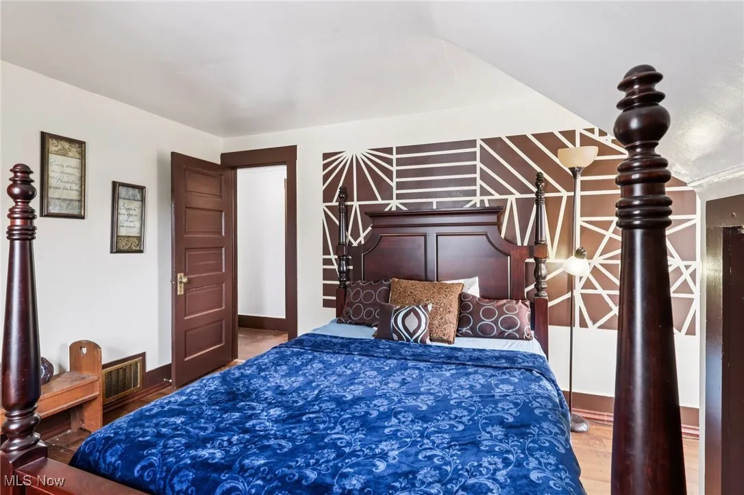 Bedroom featuring baseboards and wood finished floors