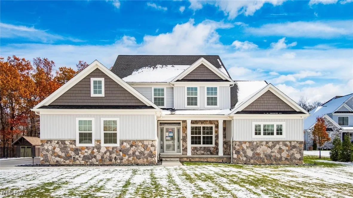 Craftsman-style house featuring a porch and stone siding