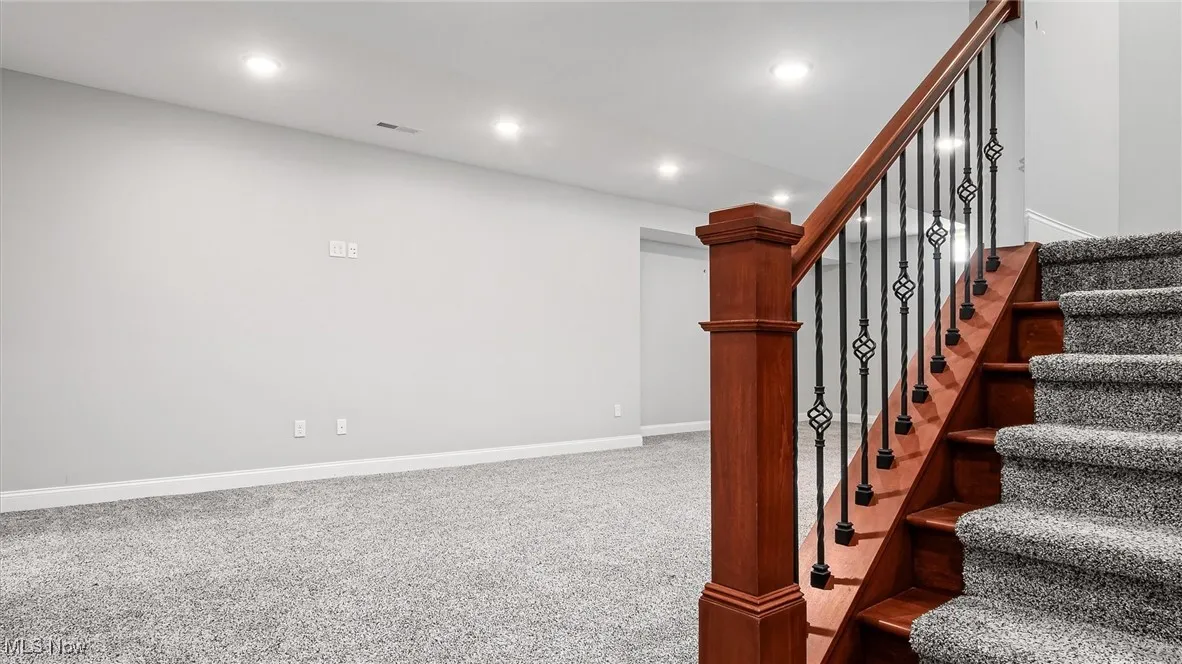 Staircase featuring recessed lighting and carpet flooring
