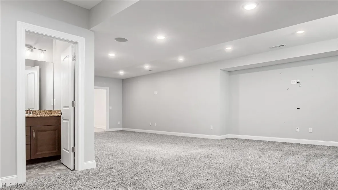 Unfurnished room featuring light colored carpet and recessed lighting