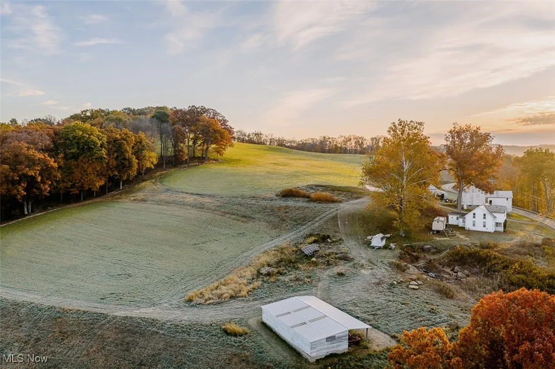 Aerial view of sparsely populated area featuring a tree filled landscape