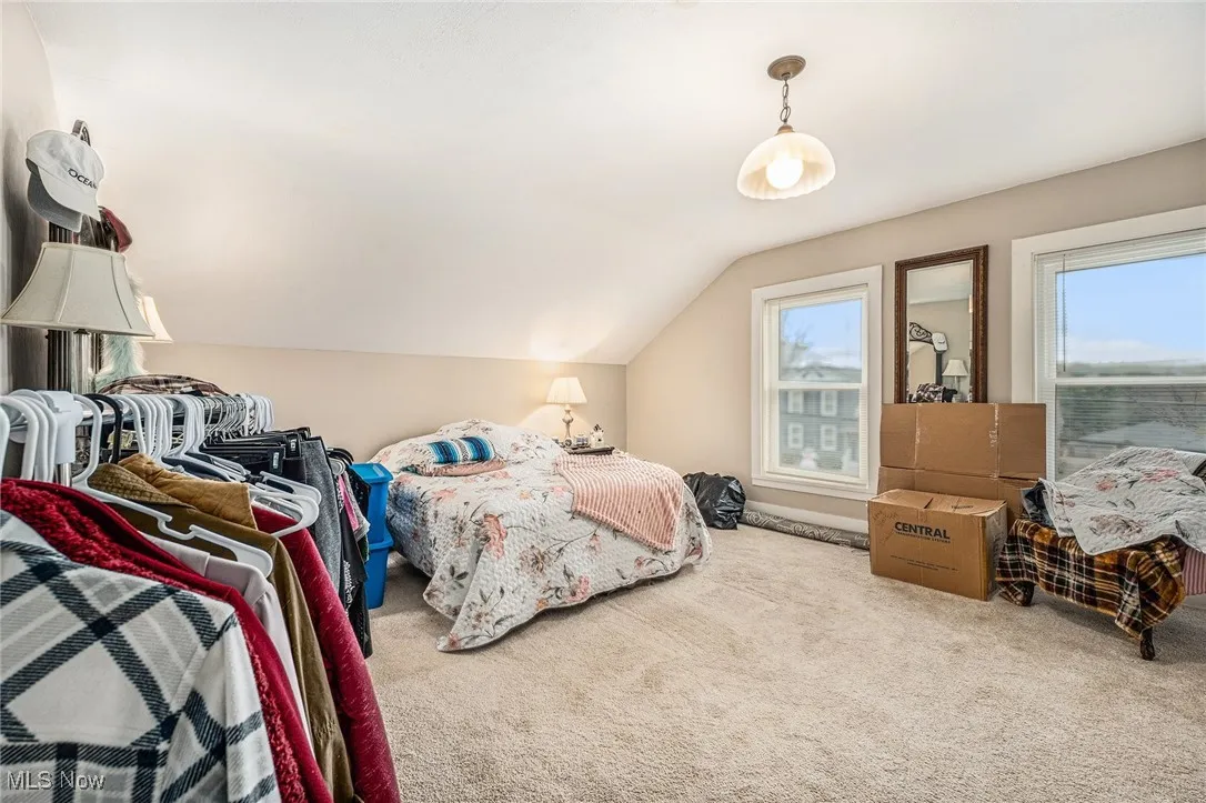 Bedroom featuring vaulted ceiling and carpet flooring
