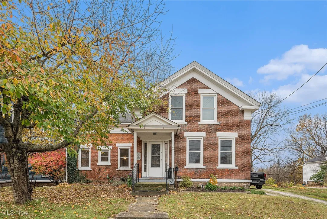View of front of property featuring brick siding and a front yard