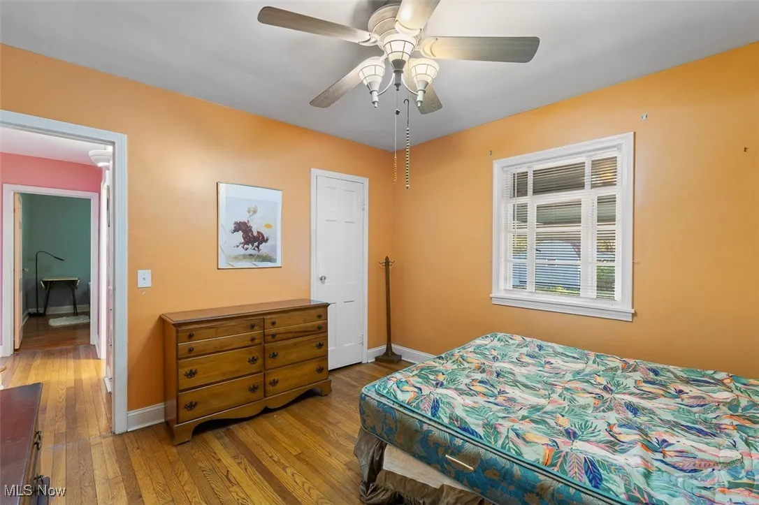 Bedroom featuring dark wood-style floors and a ceiling fan