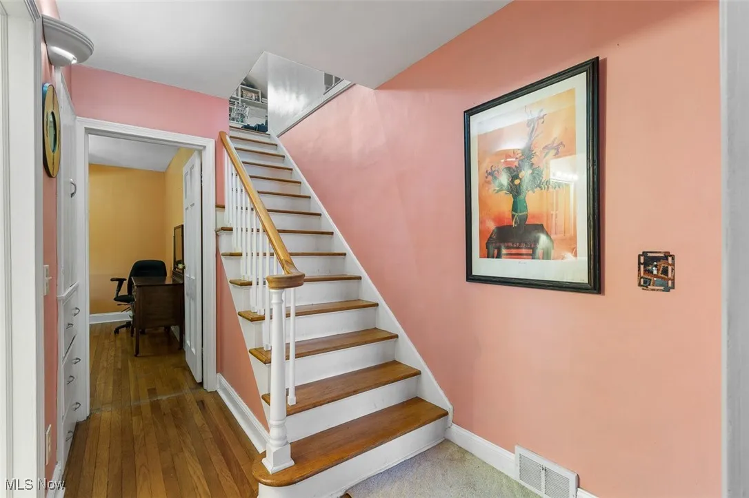 Stairs featuring baseboards and wood-type flooring