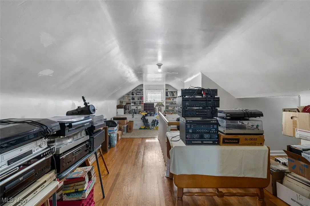 Bonus room with hardwood / wood-style floors and lofted ceiling