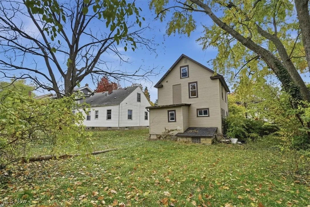 Rear view of property featuring a yard