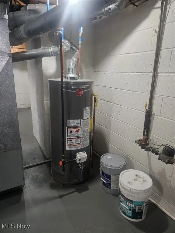 Utility room featuring gas water heater