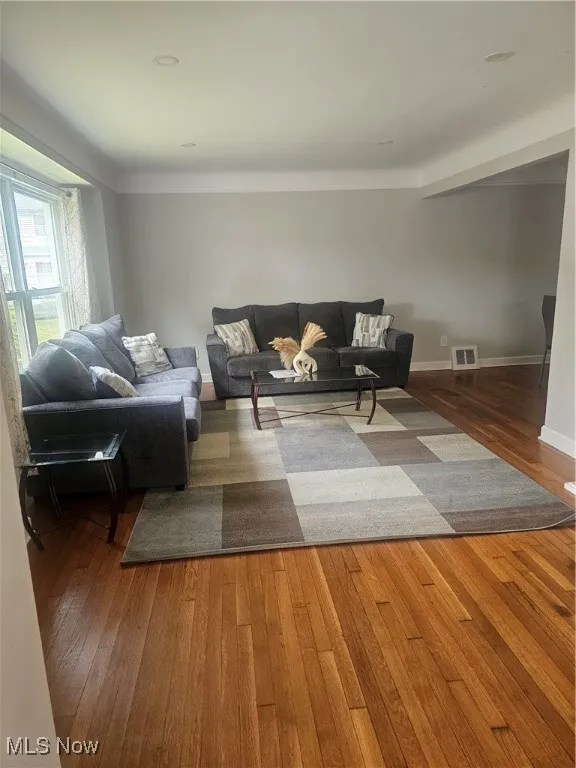 Living area featuring hardwood / wood-style floors and baseboards