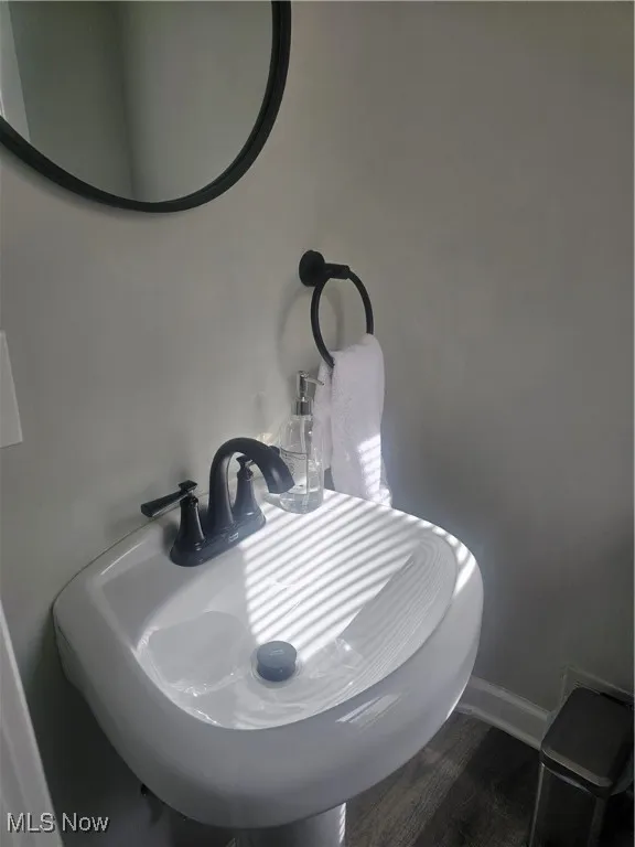 Bathroom view of a sink and baseboards