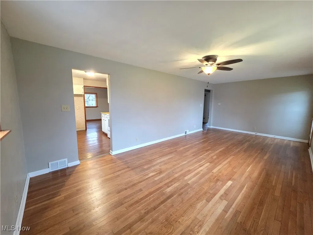 Living room featuring light wood flooring and ceiling fan
