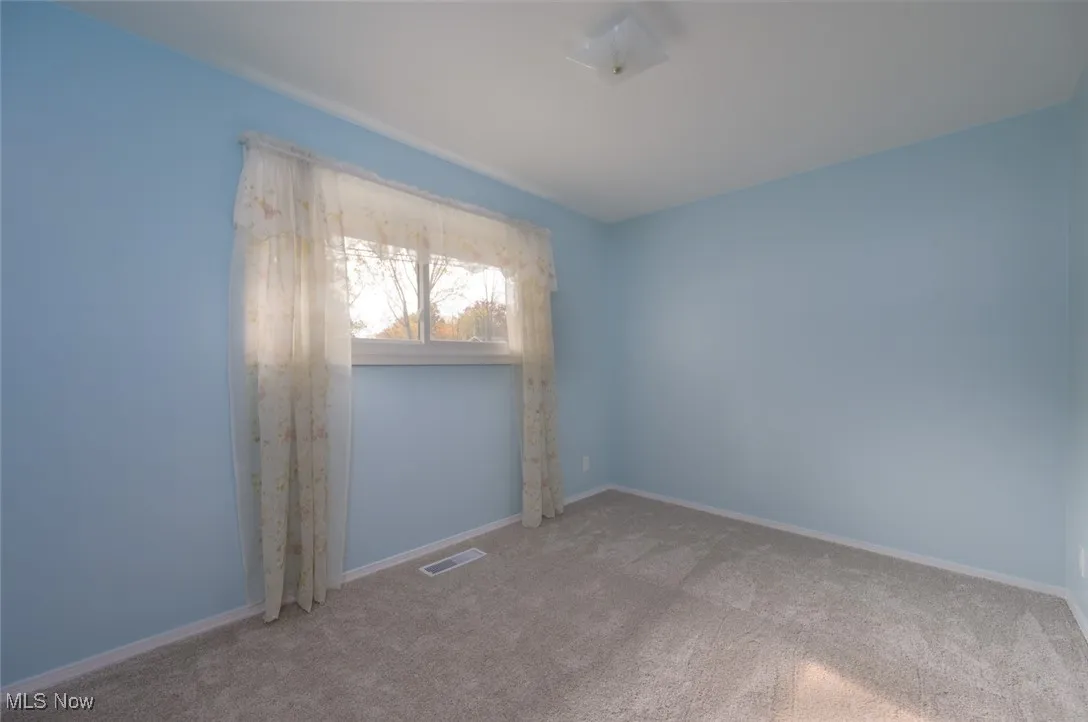 Bedroom featuring carpet and a window.