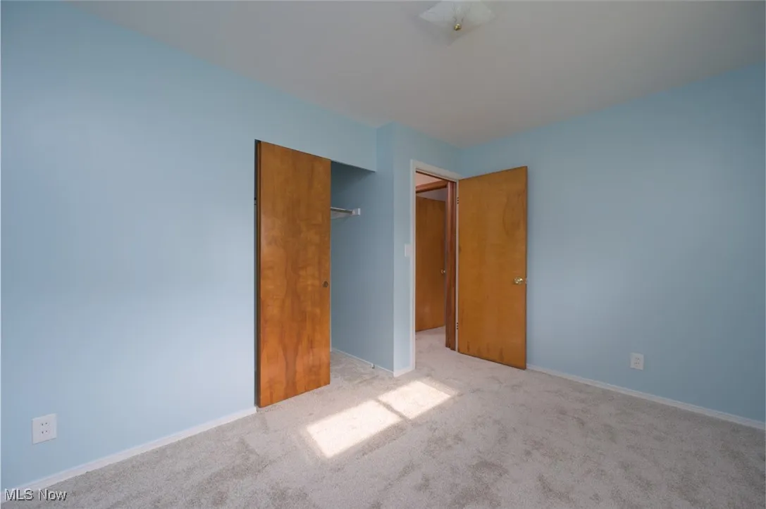 Bedroom featuring carpet and a closet.