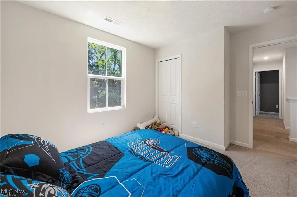 Unfurnished bedroom featuring carpet flooring and a closet
