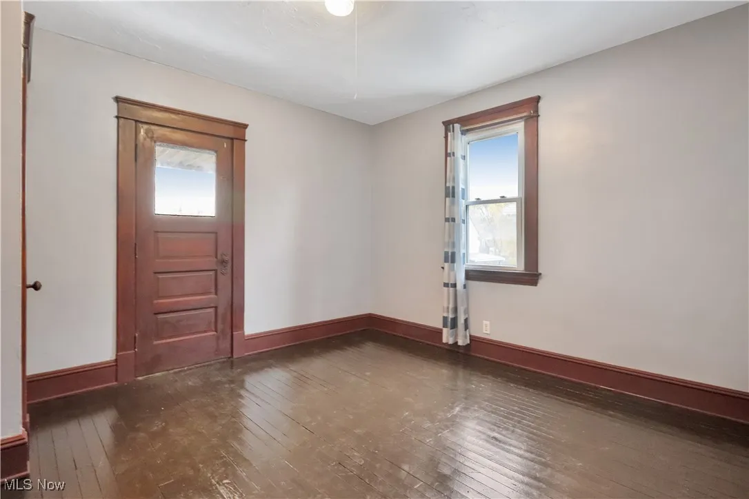 Bedroom with dark wood finished floors and​​‌​​​​‌​​‌‌​‌‌​​​‌‌​‌​‌​‌​​​‌​​ baseboards
