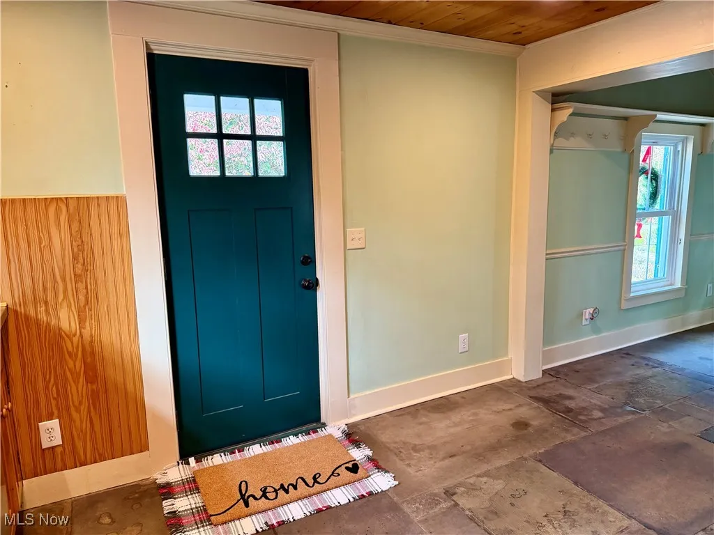 Entrance foyer featuring baseboards and wood ceiling