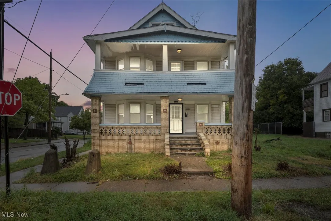 View of front of property featuring a porch and brick siding