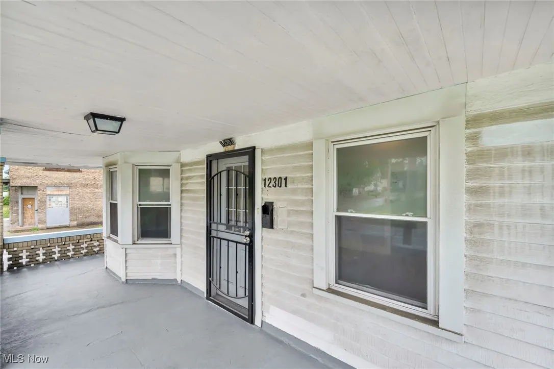 View of exterior entry with a porch