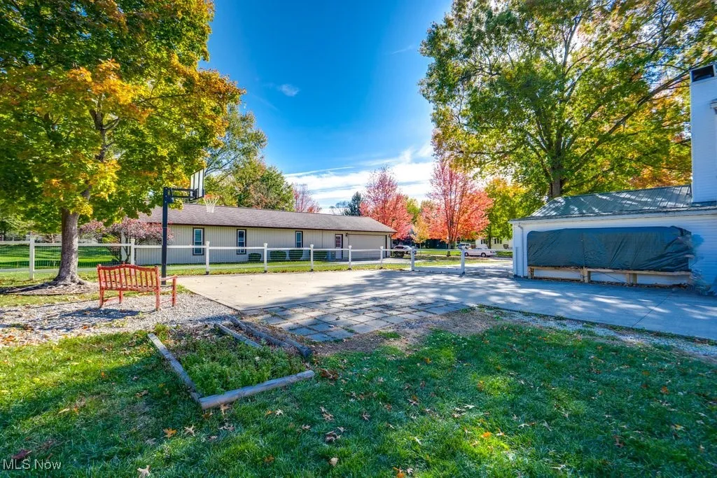 Back of property with volleyball court and a patio