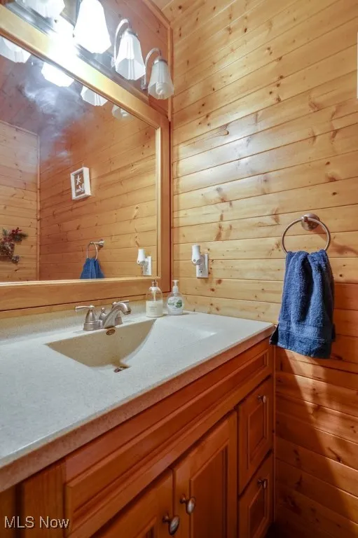 Bathroom with wood walls and vanity