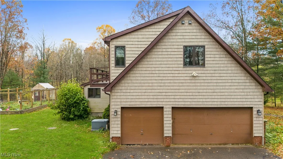 View of property exterior featuring a yard and a vegetable garden
