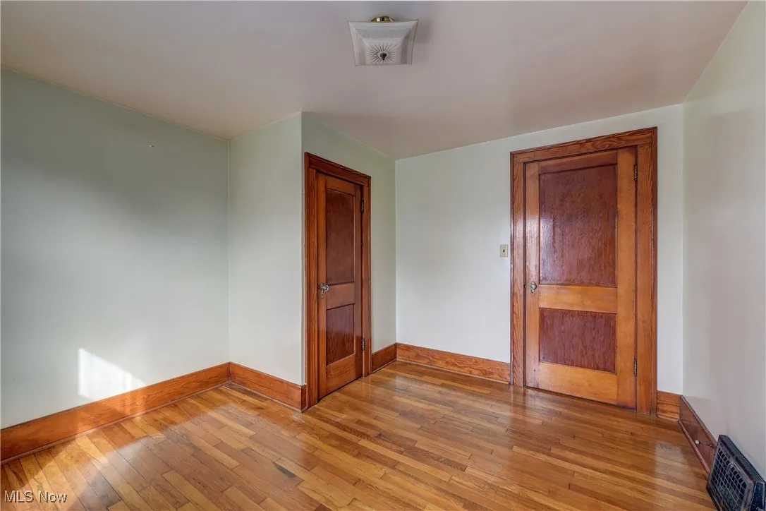 Bedroom featuring light wood flooring and baseboards