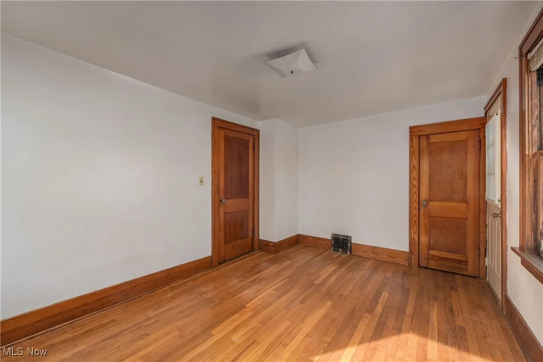 Bedroom featuring light wood flooring and baseboards
