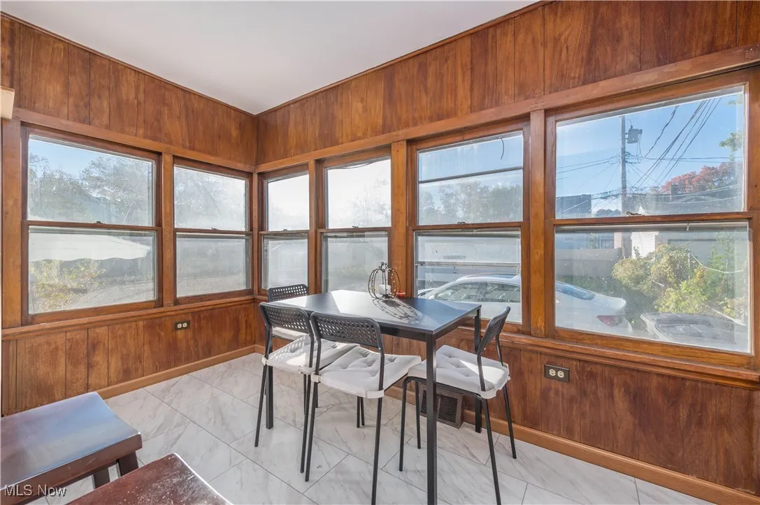 Kitchn with wooden walls and marble finish floors